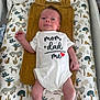 baby, infant, onesie, text_on_clothing, changing_pad, animal_print, towel, bear_ears, lying_down, newborn, cute, pattern, jungle_animals, white_clothing, red_heart, soft_texture, child, portrait, indoor, baby_garment