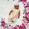 baby, infant, child, flower_headband, romper, strawberry_pattern, white_blanket, floral_design, pink_flowers, purple_flowers, lying_down, cute, portrait, soft_lighting, indoors, socks, calm_expression, baby_fashion, decorative_blanket, young_child