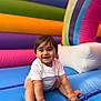Sandro is registered to the contest to win money with this photo: baby, child, smiling, infant, colorful, playground, inflatable, white_shirt, happy, sitting, indoors, cute, fun, bright_colors, young, person, skin, hair, toy, play