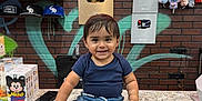 Sandro joined the competition — help win amazing prizes! toddler, child, smiling, countertop, brick_wall, neon_sign, graffiti, play_buttons, hats, plush_toys, store_interior, shorts, tshirt, bracelets, footwear_store, colorful, indoor, person, happy, cute