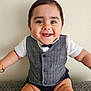baby, smiling, happy, vest, bow_tie, sitting, couch, child, infant, cute, portrait, indoor, clothing, face, arms, furniture, skin, person, expression, joy