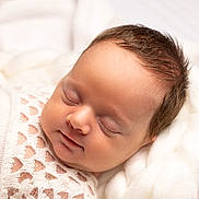 Paisley is registered to the contest to win money with this photo: baby, sleeping, infant, blanket, white, soft, cozy, knitted, cute, peaceful, resting, child, newborn, portrait, closeup, skin, face, hair, warm, comfort