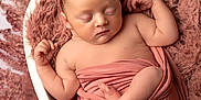 Paisley is registered to the contest to win money with this photo: newborn, baby, sleeping, heart_shaped_bowl, pink, headband, curly_hair, wrapped, soft_texture, cozy, infant, peaceful, portrait, cute, child, skin, small_feet, hands, blanket, studio_photo