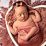 newborn, baby, sleeping, heart_shaped_bowl, pink, headband, curly_hair, wrapped, soft_texture, cozy, infant, peaceful, portrait, cute, child, skin, small_feet, hands, blanket, studio_photo