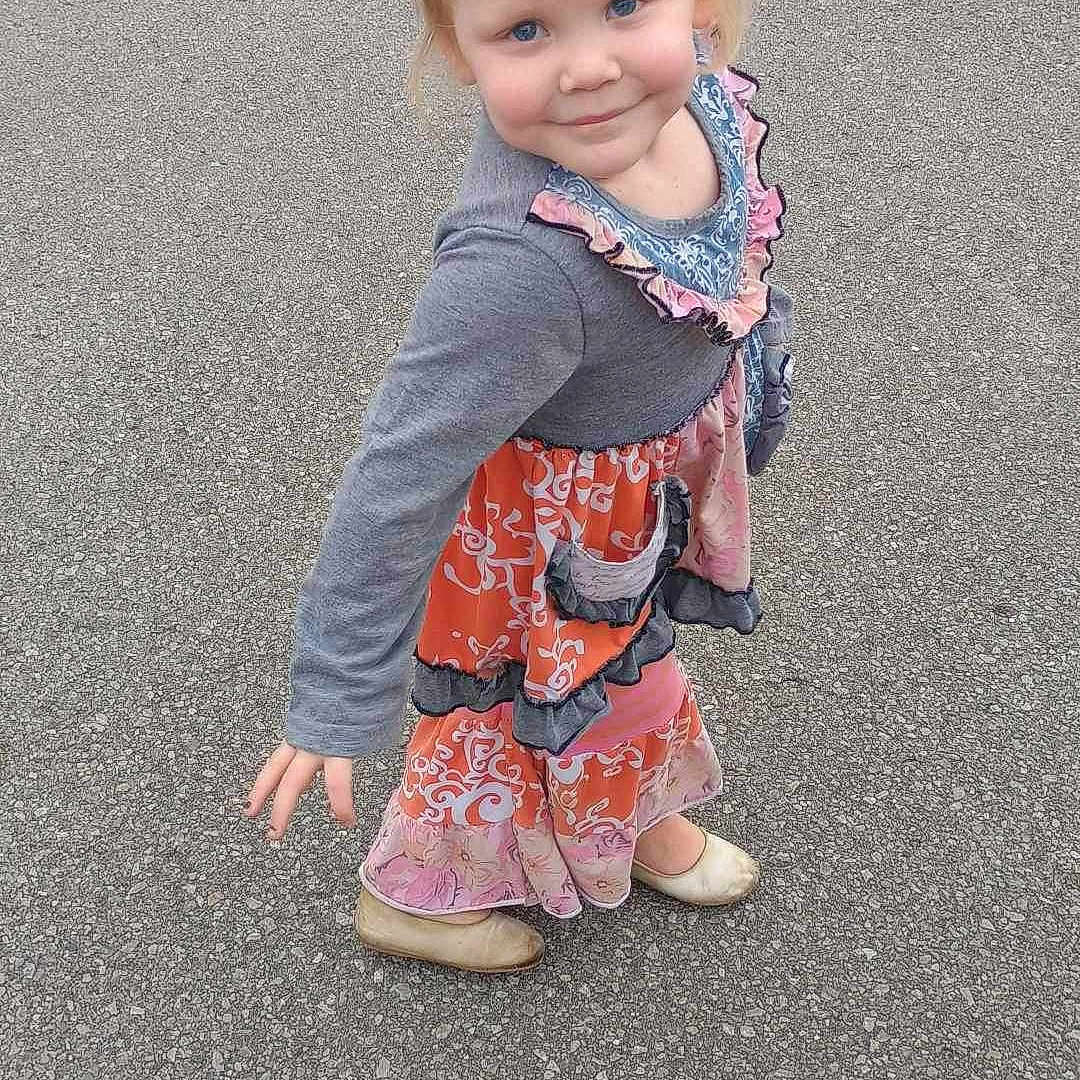 Harper joined the competition — help win amazing prizes! asphalt, blonde_hair, blue_eyes, casual, child, colorful_clothing, cute, daylight, dress, fashion, girl, gray_top, outdoor, pigtails, playful_pose, portrait, shoes, smiling, standing, young_child