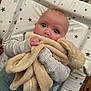 Zoe joined the competition — help win amazing prizes! baby, blanket, bunny, child, clothing, cute, face, furniture, hand, infant, pattern, person, plush, portrait, soft_toy, star_pattern, table, toy, wearing, wide_eyes
