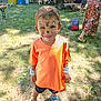 Bradley a rejoint le concours — aidez-le/la à gagner de superbes lots ! blue_sandals, boy, casual_clothing, child, daytime, event, face_paint, festival, fun, grass, happy, nature, orange_tshirt, outdoor, people, picnic, playful, smiling, summer, sunlight