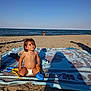 barefoot, beach, blanket, blue, child, fun, holiday, ocean, outdoor, pattern, playing, sand, shadow, sky, summer, sunlight, toddler, toy, vacation, water