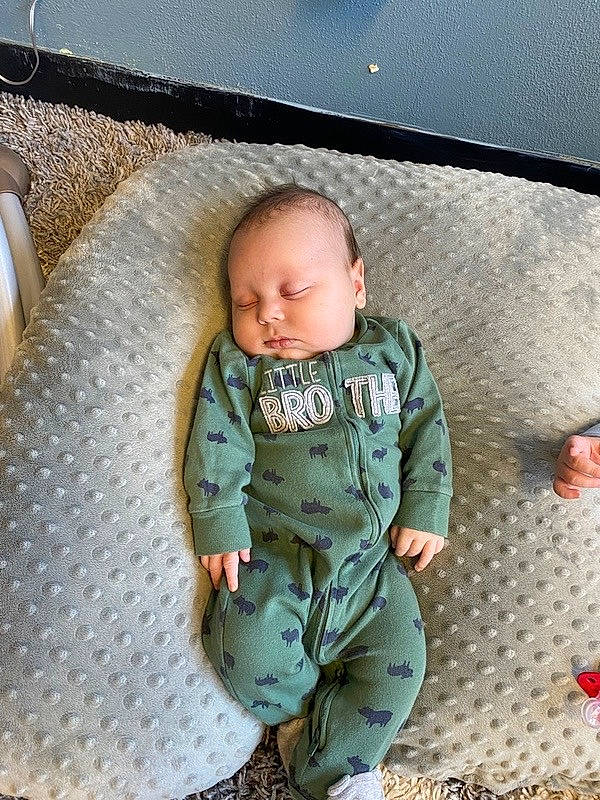 Axel is registered to the contest to win money with this photo: baby, baby_toddler_clothing, camouflage, child, comfort, face, flooring, fun, grass, linens, military_camouflage, military_uniform, pattern, person, sitting, skin, sleeve, soldier, t_shirt, toddler