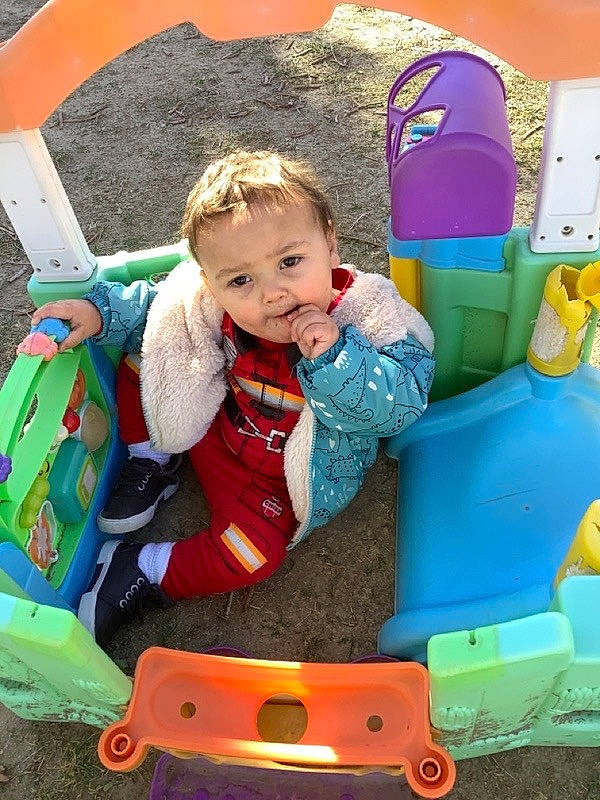 Justin is registered to the contest to win money with this photo: baby, baby_carriage, baby_playing_with_toys, baby_products, baby_toddler_clothing, baby_toys, child, comfort, fun, grass, happy, leisure, person, play, product, recreation, riding_toy, sitting, smile, toddler