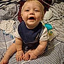 Eric is registered to the contest to win money with this photo: baby, child, smiling, sitting, bed, bedding, blanket, clothing, denim, overalls, bib, happy, indoor, person, face, foot, hand, striped, toddler, cute