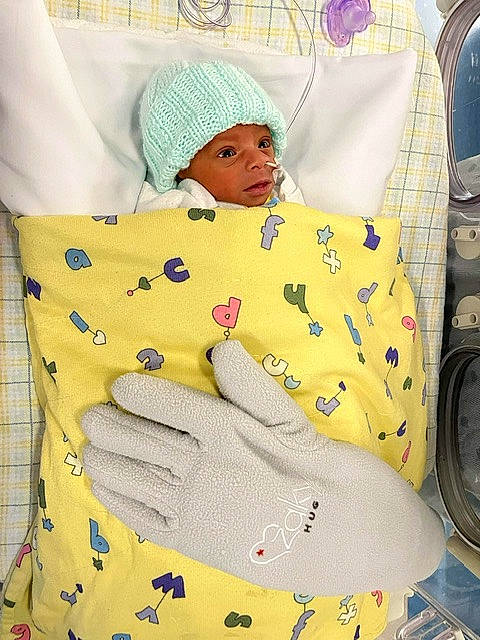 Cairo is registered to the contest to win money with this photo: arm, art, baby, baby_products, baby_sleeping, beanie, button, cap, child, comfort, hat, headgear, headwear, knit_cap, linens, pattern, person, sitting, sleeve, stuffed_toy