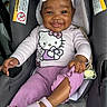 Leilani joined the competition — help win amazing prizes! baby, child, car_seat, smiling, headband, hello_kitty, pink_clothing, shoes, cute, infant, happy, portrait, seatbelt, toddler, indoors, apparel, accessory, person, young_child, fashion