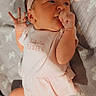 Penelopy joined the competition — help win amazing prizes! baby, newborn, infant, child, portrait, lying_down, pink_outfit, headband, bow, blanket, bed, indoors, face, hands, fist, smiling, eyes, soft_lighting, cozy, photography