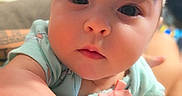Penelopy joined the competition — help win amazing prizes! baby, infant, child, portrait, close_up, wide_eyes, bow, headband, mint_green_outfit, smiling, indoors, candid, face, eyes, hand, sitting, lap, home, soft_lighting, adorable