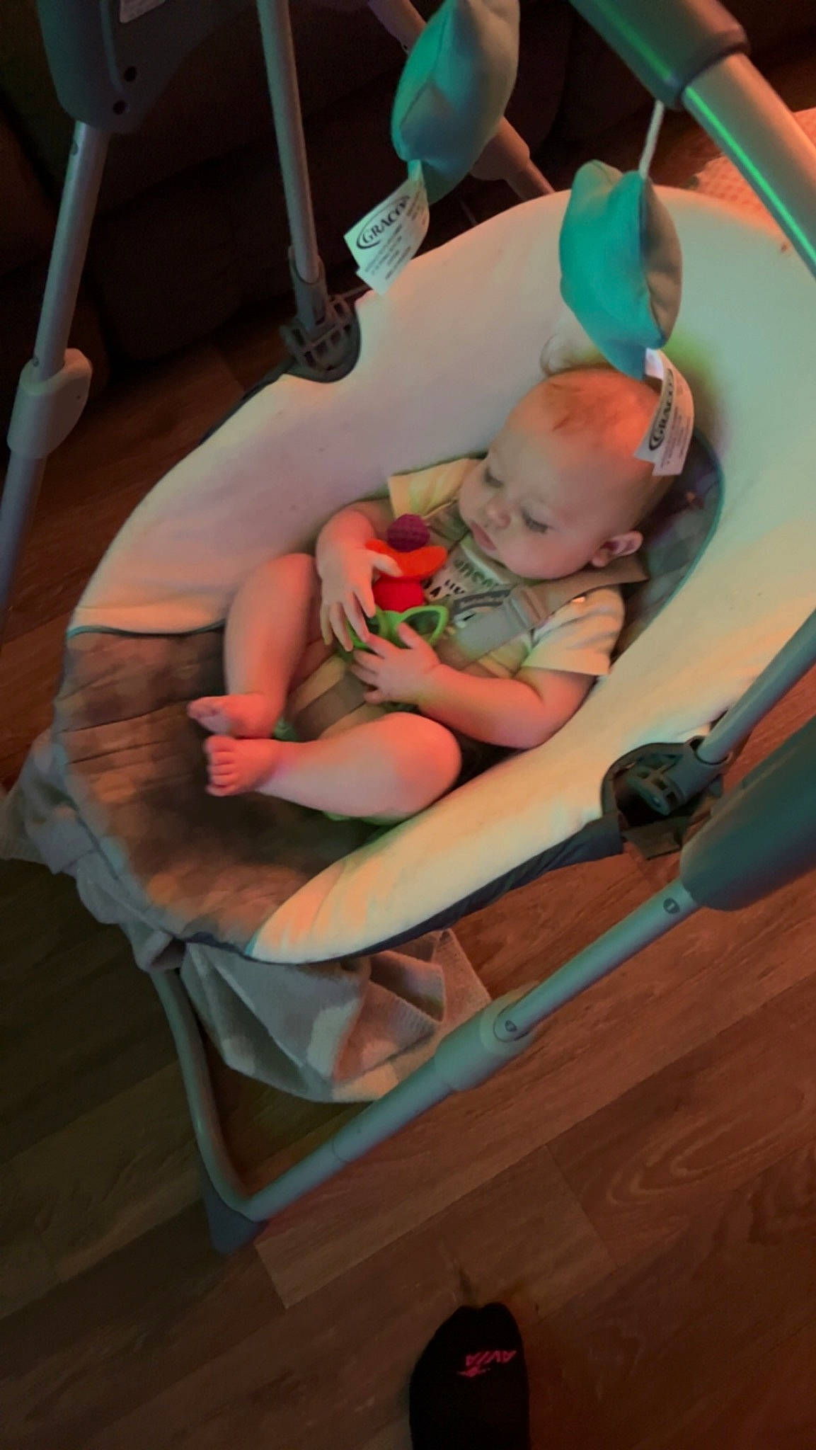 Troy is registered to the contest to win money with this photo: baby, baby_products, baby_toddler_clothing, chair, circle, comfort, flooring, foot, fun, hardwood, human_leg, knee, lap, leisure, person, recreation, room, sitting, thigh, toddler