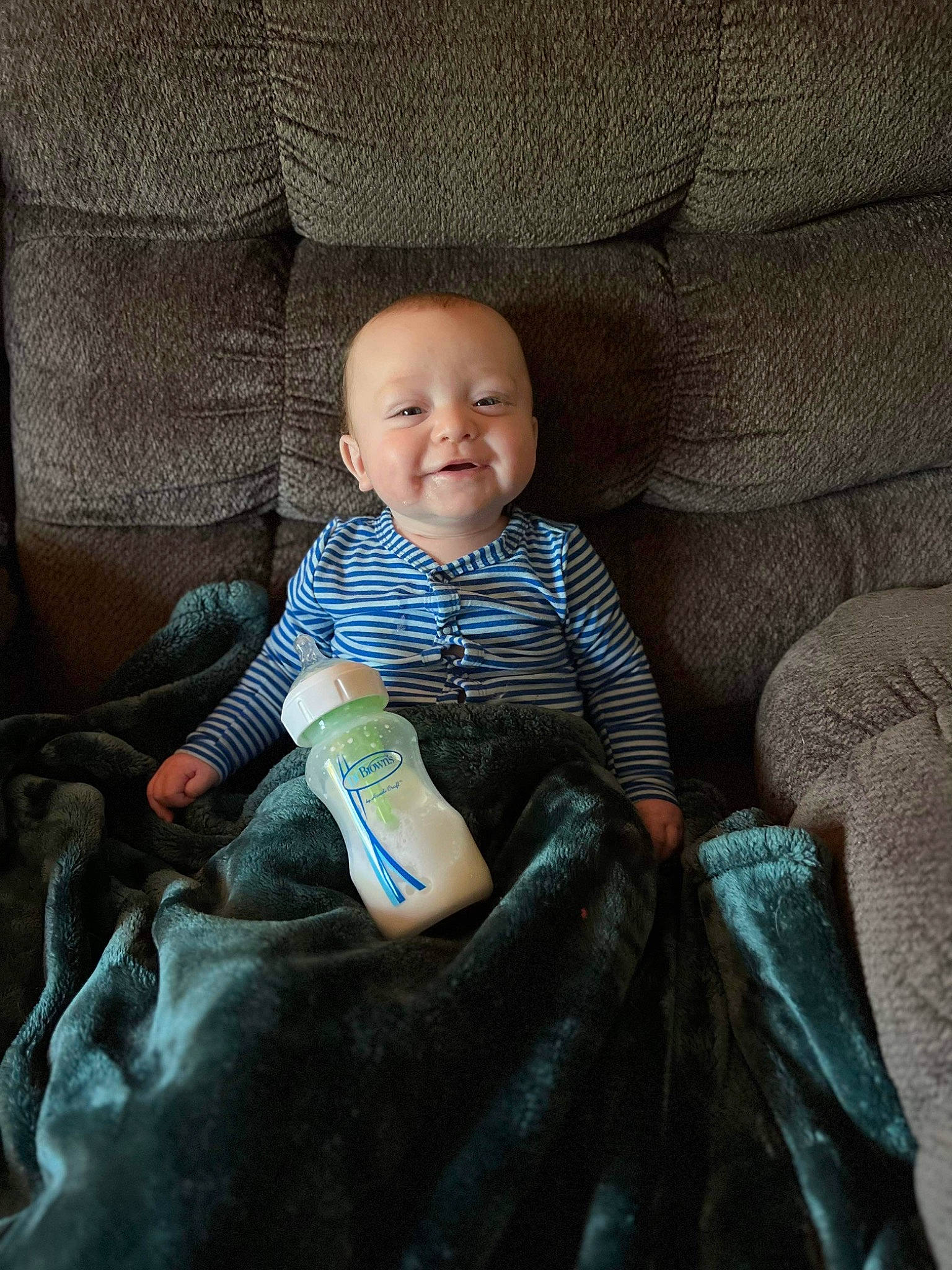 Troy is registered to the contest to win money with this photo: auto_part, baby, baby_toddler_clothing, car_seat, cheek, child, comfort, electric_blue, finger, fun, human, human_body, joy, lap, leg, linens, person, room, sitting, skin