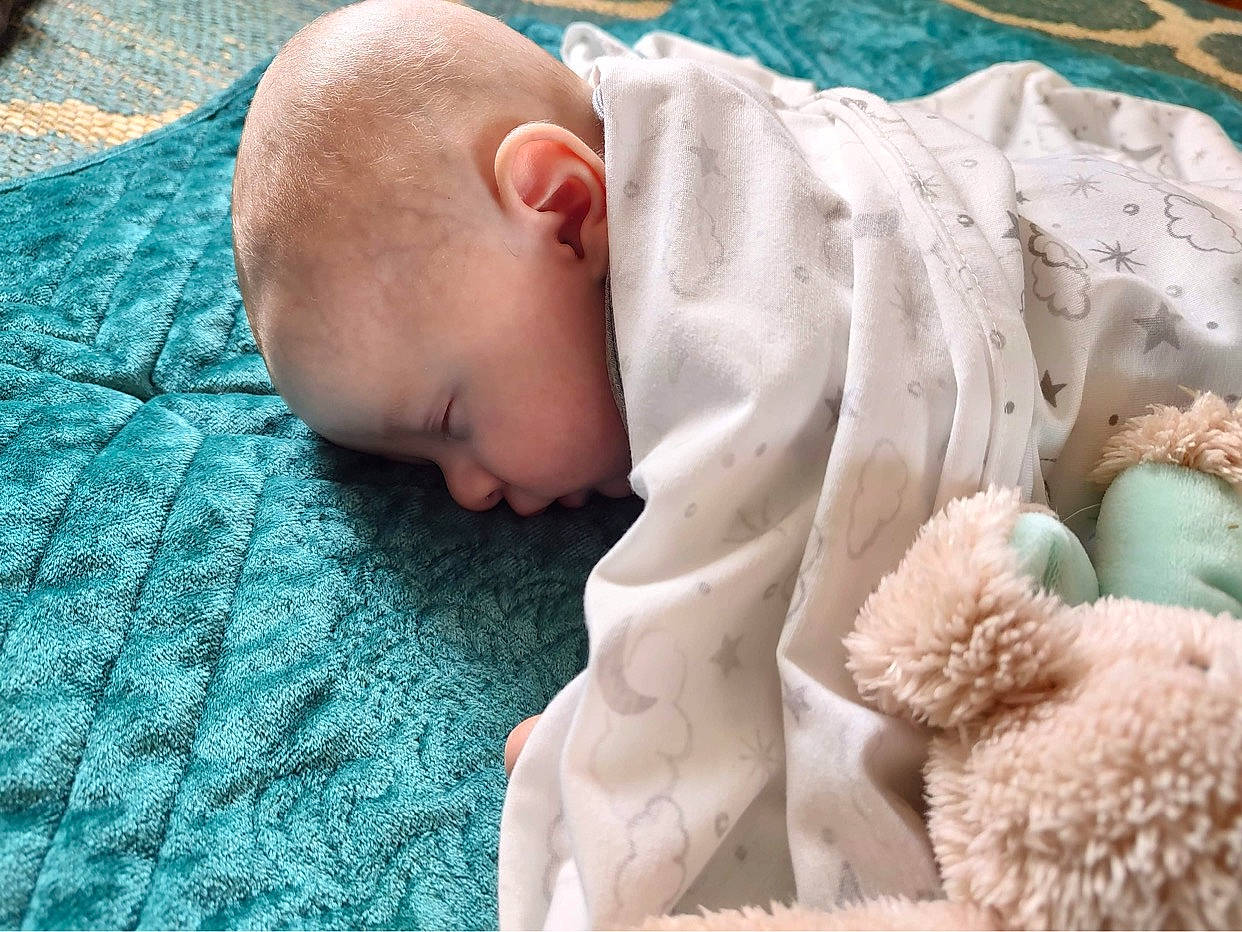 Braylon is registered to the contest to win money with this photo: baby, baby_products, baby_safety, baby_sleeping, baby_toddler_clothing, child, comfort, fur, grass, linens, mammal, pattern, people, person, skin, stuffed_toy, teddy_bear, textile, toddler, toy