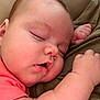 baby, sleeping, close_up, chubby_cheeks, infant, peaceful, hand, skin, face, resting, soft, cute, pink_clothing, portrait, child, young, nap, indoors, relaxed, peace