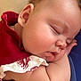 baby, sleeping, closeup, face, cheek, arm, red_clothing, white_clothing, skin, peaceful, infant, child, portrait, cute, resting, indoors, soft_light, young, toddler, relaxing