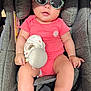 baby, baby_hands, baby_legs, car_seat, casual, child, chubby, comfort, coral_onesie, cute, fabric_texture, indoor, infant, plush_toy, portrait, reflection, relaxed, seatbelt, sunglasses, sunlight