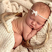 Elliana is registered to the contest to win money with this photo: baby, newborn, sleeping, blanket, knit, headband, bow, antlers, woodland, soft, cozy, portrait, cute, peaceful, infant, skin, texture, resting, warm, decor
