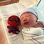 Miles joined the competition — help win amazing prizes! newborn, baby, sleeping, hospital, blanket, swaddled, plush_toy, spiderman, marvel, bed, face, hat, infant, resting, cute, child, soft_toy, indoors, person, peaceful