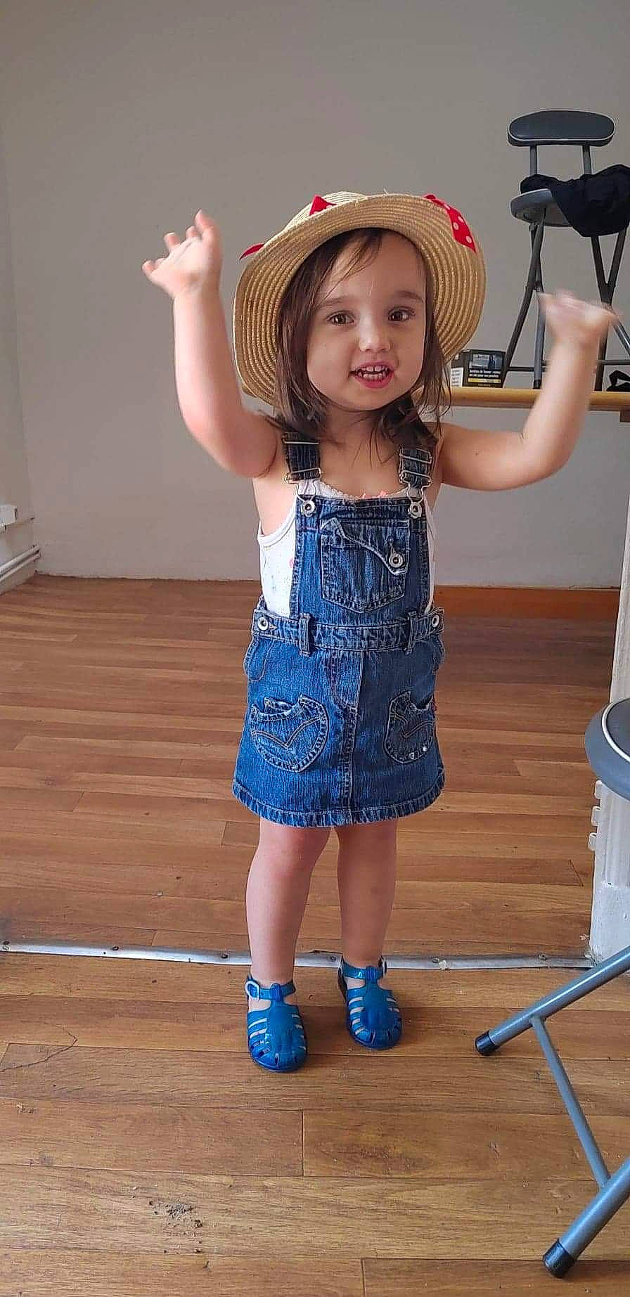 Tania participe au concours pour gagner de l'argent avec cette photo : baby_toddler_clothing, blue, dress, flash_photography, flooring, fun, happy, hat, joint, leg, person, shoulder, skin, smile, standing, sun_hat, thigh, toddler, trunk, waist