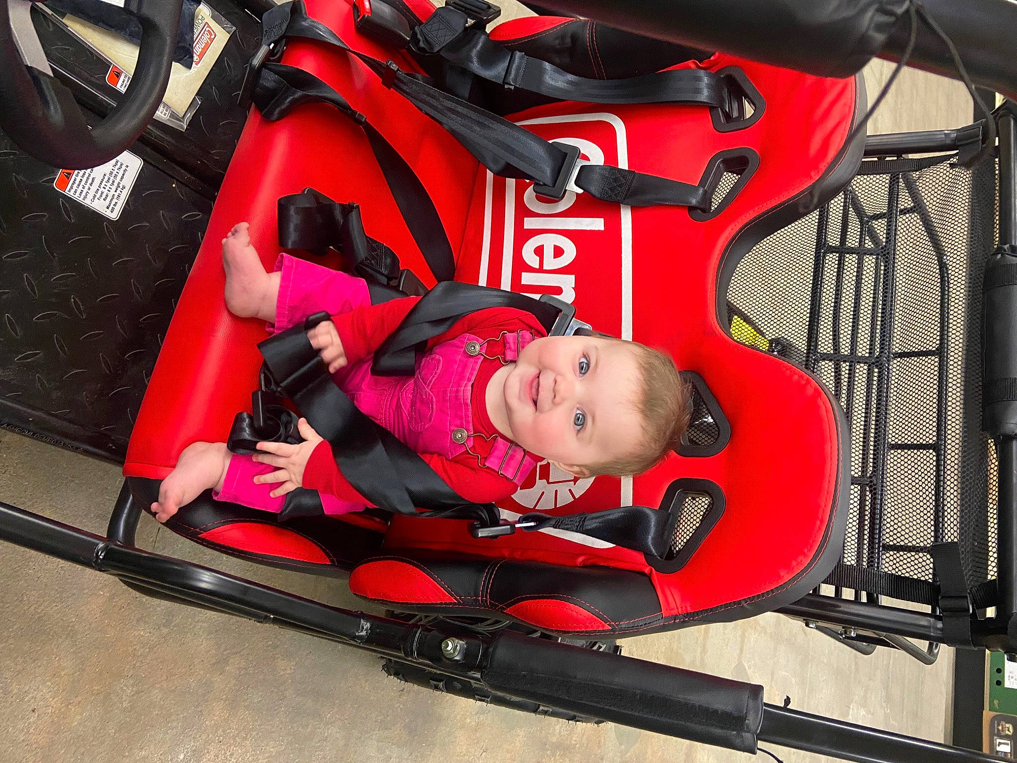 Emberlyn is registered to the contest to win money with this photo: auto_part, automotive_design, automotive_exterior, automotive_wheel_system, baby, baby_carriage, baby_products, bumper, carmine, child, fun, joy, leisure, motor_vehicle, person, personal_protective_equipment, recreation, toddler, transport, vehicle