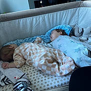 Louie And Oliver joined the competition — help win amazing prizes! baby, sleeping, playpen, blanket, plush_toy, onesie, infant, cozy, indoor, peaceful, child, bedroom, star_pattern, checkered_pattern, toy, christmas_calendar, soft_toy, naptime, resting, cute