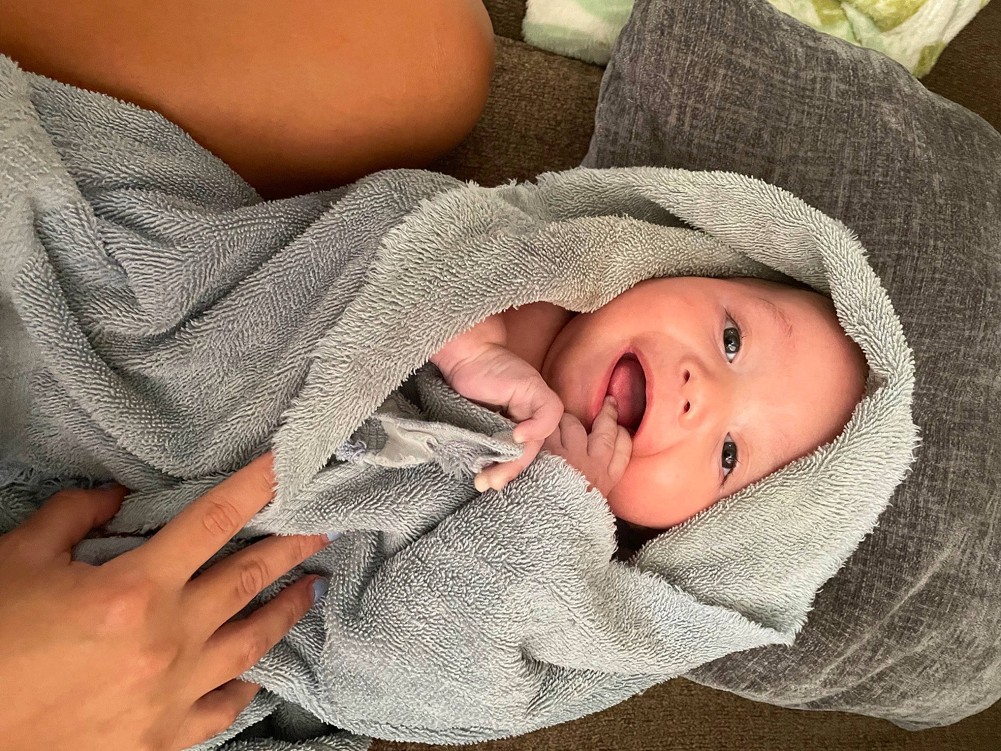 Hero is registered to the contest to win money with this photo: baby, baby_toddler_clothing, cheek, child, comfort, eye, finger, gesture, hat, headwear, linens, mammal, mouth, nail, nose, pattern, person, skin, sleeve, smile