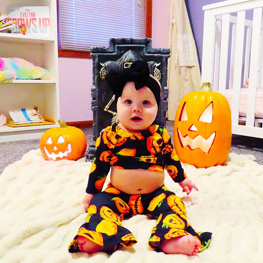 Evelynn joined the competition — help win amazing prizes! baby_products, baby_toddler_clothing, baby_toys, black_hair, calabaza, child, cool, costume, fun, head, orange, person, play, product, pumpkin, room, sitting, toddler, toy, trick_or_treat