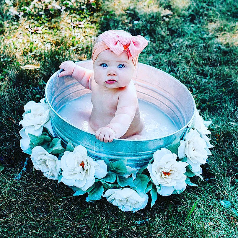 Evelynn joined the competition — help win amazing prizes! baby, bathtub, child, flower, grass, hair_accessory, headgear, headwear, person, petal, plant, product, toddler, turquoise