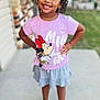 child, girl, smiling, curly_hair, pink_shirt, minnie_mouse, skirt, standing, outdoor, sidewalk, house, confident, happy, earrings, shoes, young, portrait, casual_clothing, daylight, background_blur
