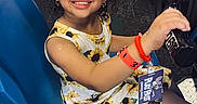 Zai'Lynn is registered to the contest to win money with this photo: arcade, arcade_game, blue_seat, bracelet, child, entertainment, face_stickers, fun, game_machine, girl, happy, indoor, playing, racing_game, seat, smiling, steering_wheel, sunflower_dress, white_bow, wristband