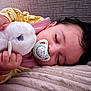 Yousra participe au concours pour gagner de l'argent avec cette photo : baby, sleeping, pacifier, stuffed_animal, plush_toy, blanket, close_up, face, hand, infant, child, cozy, resting, soft_texture, indoors, cute, peaceful, portrait, toddler, comfort