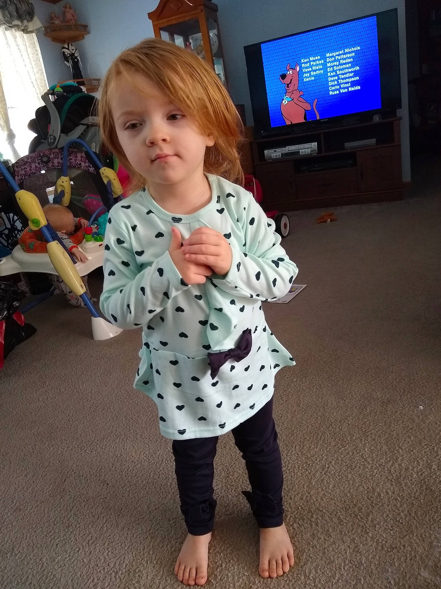 Desirée is registered to the contest to win money with this photo: cable_television, child, design, event, floor, flooring, fun, happy, home_appliance, joint, leg, leisure, pattern, person, sleeve, standing, t_shirt, television, television_set, toddler