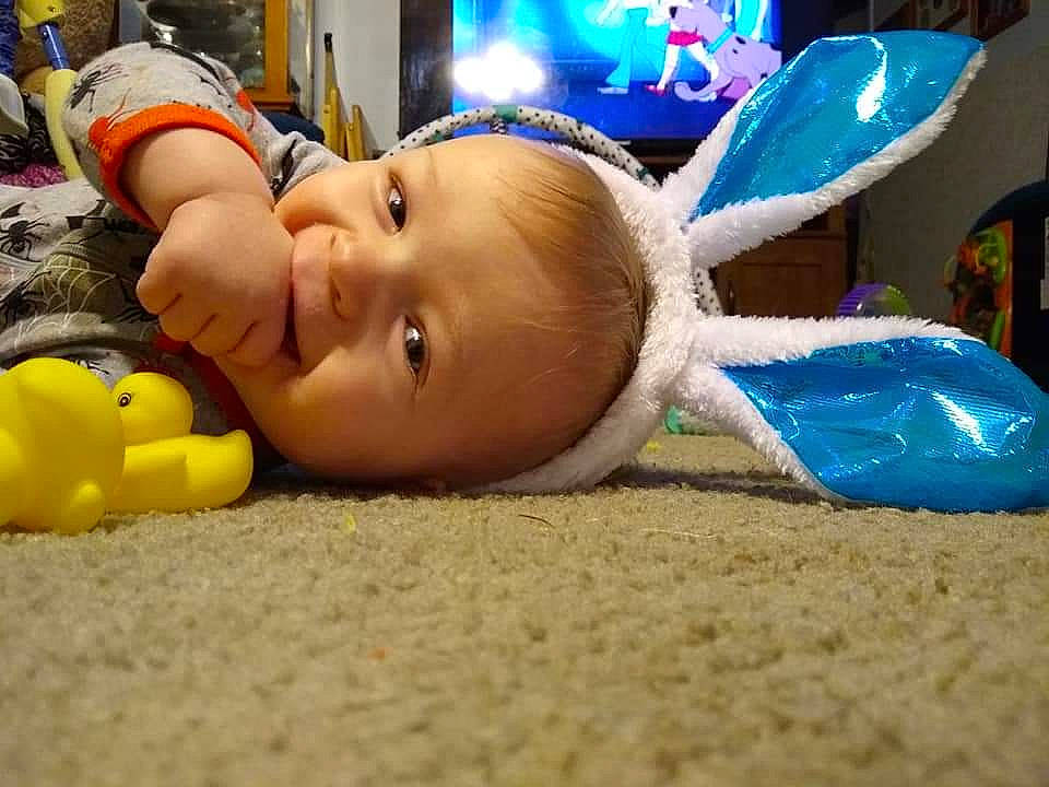 Wyatt is registered to the contest to win money with this photo: baby, baby_products, baby_toys, child, flooring, fun, grass, happy, leisure, person, personal_protective_equipment, plastic, play, recreation, room, smile, toddler, toy, wood