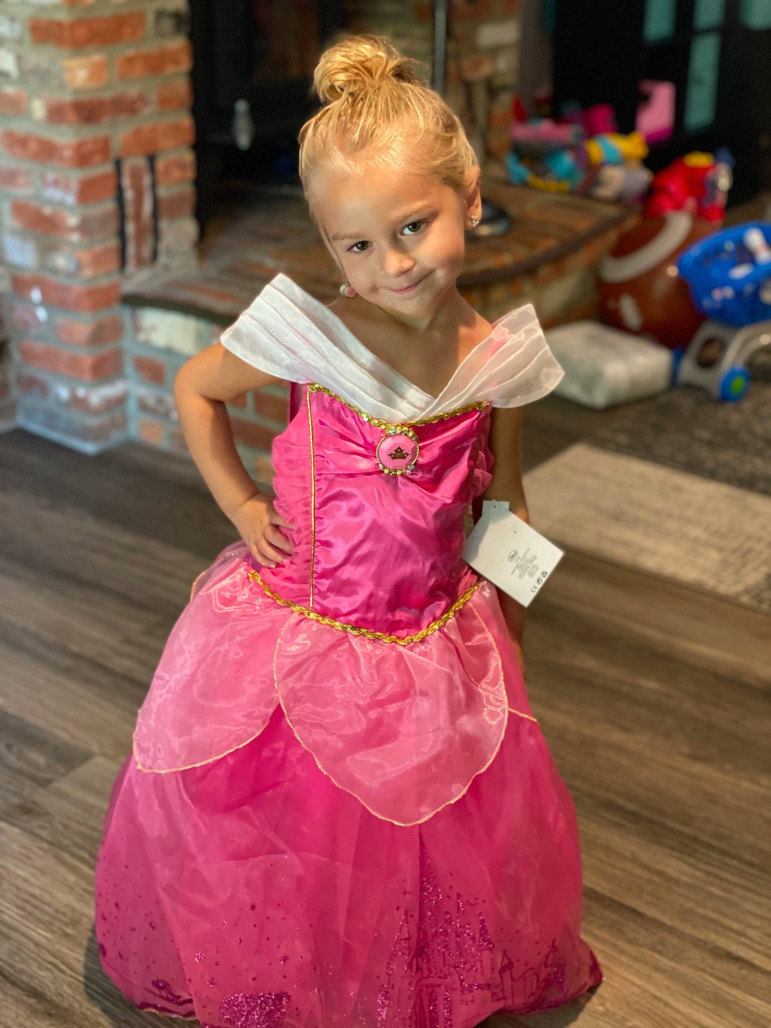 Teagan is registered to the contest to win money with this photo: baby_toddler_clothing, child, dress, embellishment, entertainment, event, face, fashion_design, flooring, fun, hair, happy, joy, leisure, magenta, performing_arts, person, pink, purple, smile
