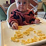 baby, high_chair, snack, indoor, child, food, table, furniture, person, cute, expression, cozy, modern, casual, seat, plate, eating, young_child, curious, comfortable