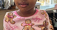 Jaiya joined the competition — help win amazing prizes! blinds, casual, child, curious, curly_hair, cute, expression, gingerbread_men, girl, hairstyle, indoor, long_sleeves, natural_light, patterned_clothing, person, pink_shirt, portrait, standing, window, young