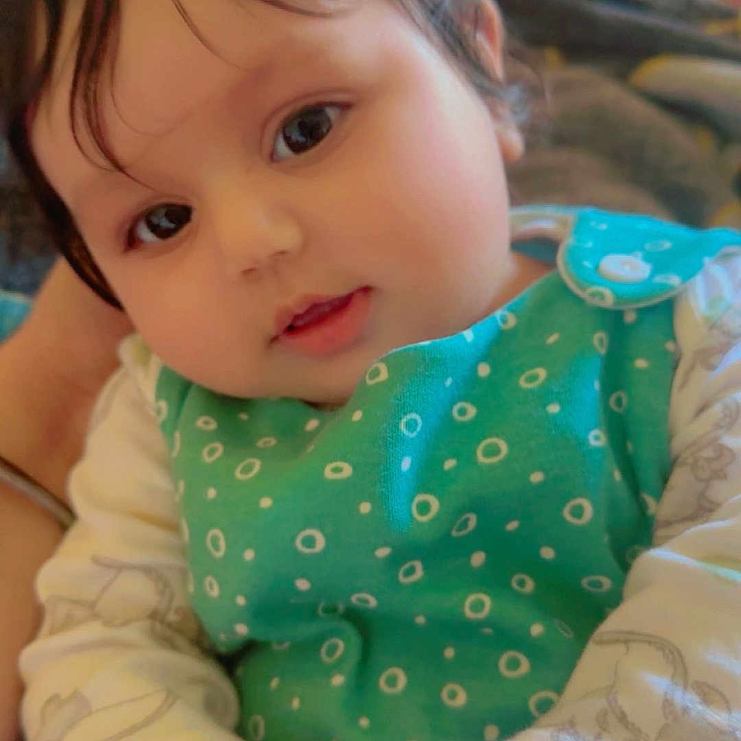 Arzoi is registered to the contest to win money with this photo: baby, child, closeup, clothing, cute, expression, eyes, face, green_outfit, hands, head, indoors, infant, person, polka_dots, portrait, sitting, skin, soft_light, young_child