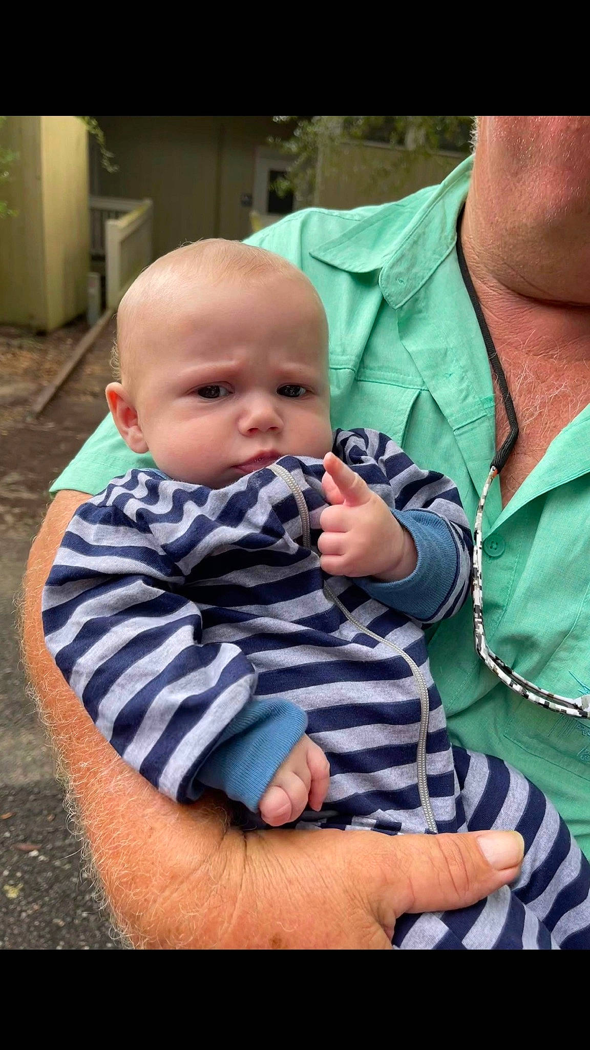 Jackson is registered to the contest to win money with this photo: baby, baby_products, baby_toddler_clothing, cheek, child, comfort, flooring, fun, gesture, grass, happy, lap, pattern, person, sitting, skin, sleeve, t_shirt, thumb, toddler