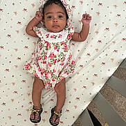 Kalaysia joined the competition — help win amazing prizes! baby, infant, crib, floral_outfit, bonnet, sandals, footwear, patterned_sheet, flower_pattern, lying_down, indoors, carpet, curious_eyes, child, cute, person, baby_clothing, foot, hand, headwear