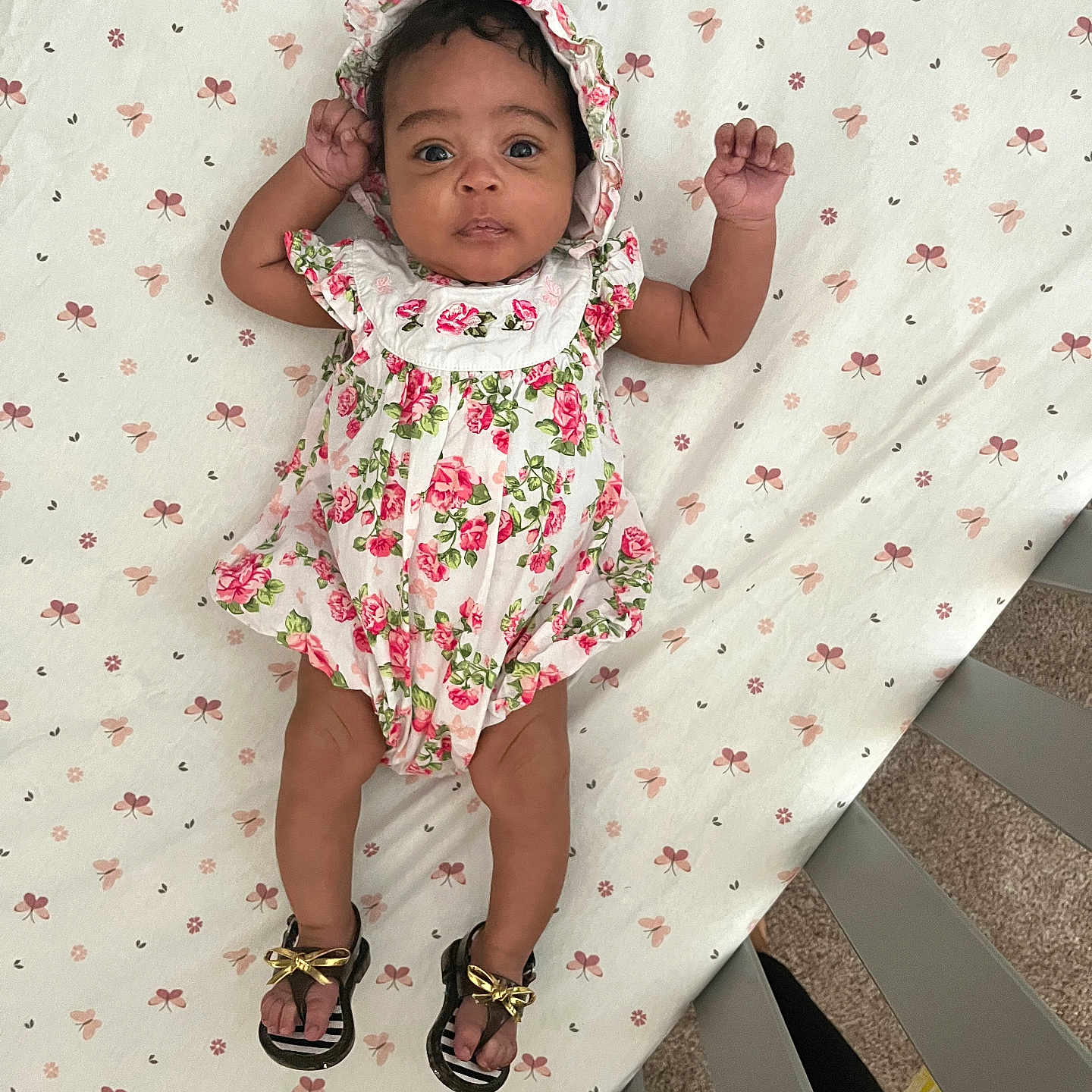 Kalaysia joined the competition — help win amazing prizes! baby, baby_clothing, bonnet, carpet, child, crib, curious_eyes, cute, floral_outfit, flower_pattern, foot, footwear, hand, headwear, indoors, infant, lying_down, patterned_sheet, person, sandals