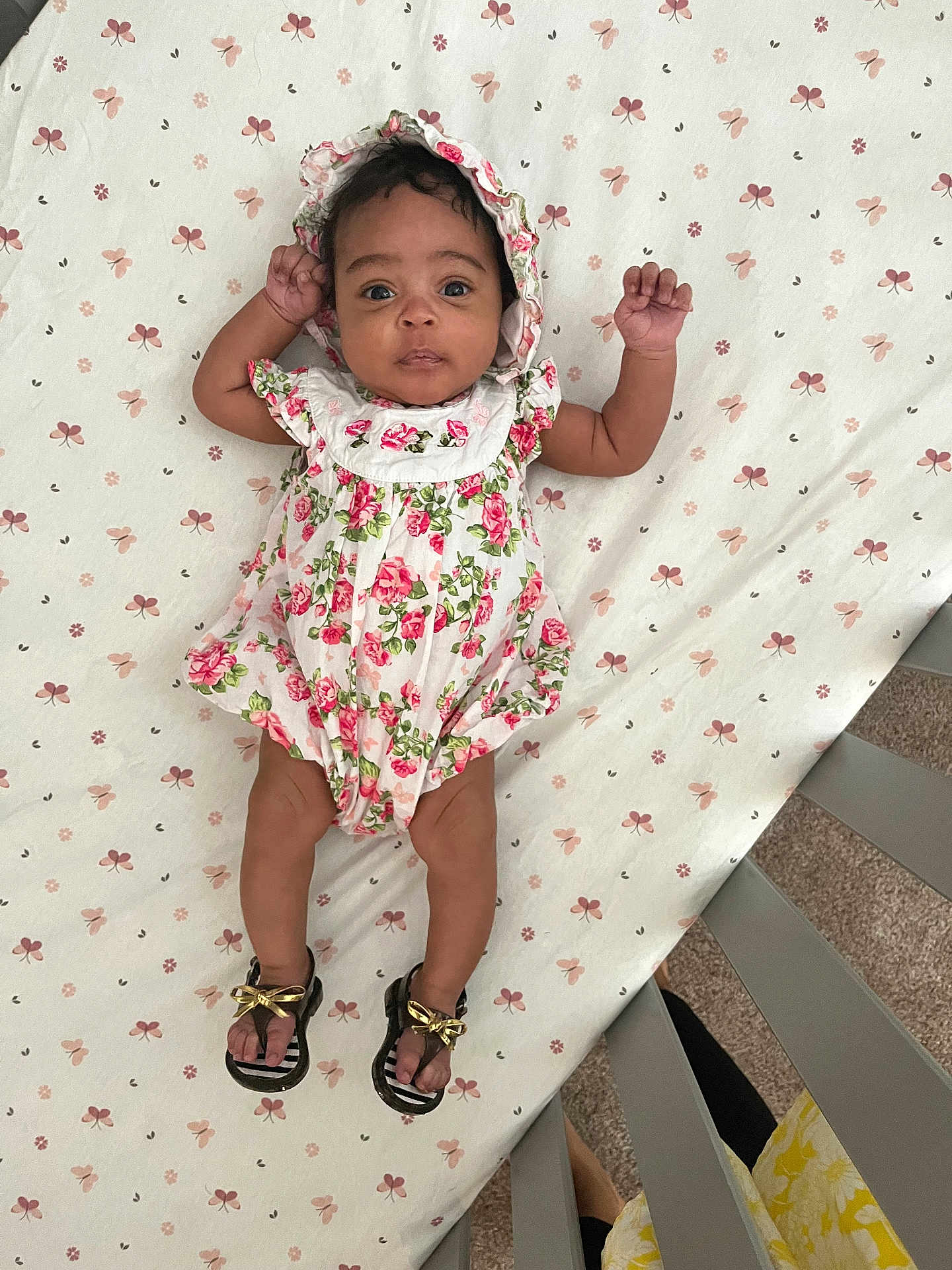 Kalaysia joined the competition — help win amazing prizes! baby, infant, crib, floral_outfit, bonnet, sandals, footwear, patterned_sheet, flower_pattern, lying_down, indoors, carpet, curious_eyes, child, cute, person, baby_clothing, foot, hand, headwear