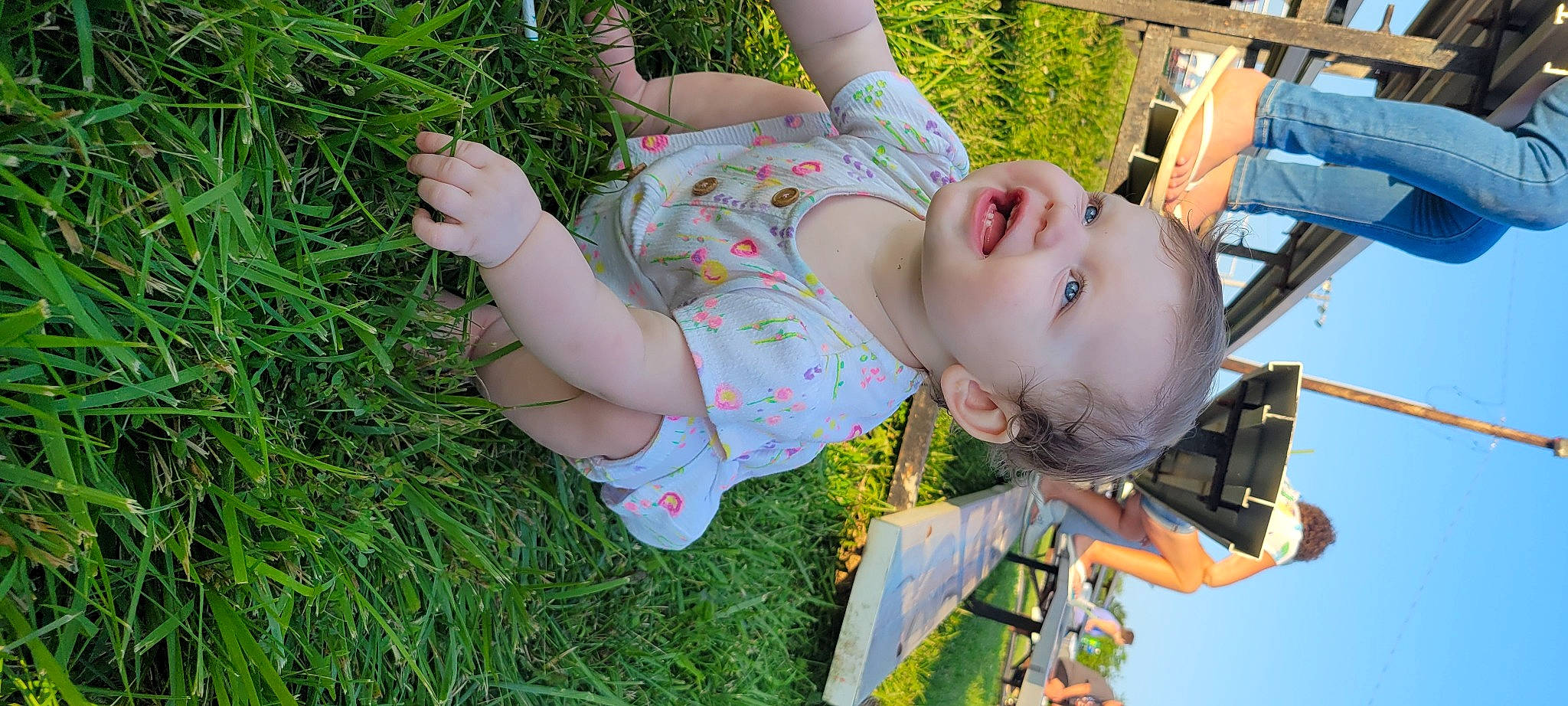 Lyla joined the competition — help win amazing prizes! baby, baby_toddler_clothing, child, fun, grass, grassland, hand, happy, leisure, outdoor_play_equipment, pattern, people_in_nature, person, plant, play, recreation, skin, summer, swing, toddler