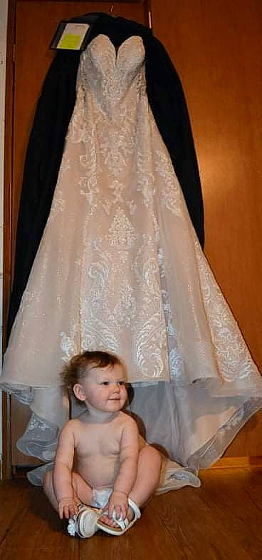 Lyla is registered to the contest to win money with this photo: arm, bridal_clothing, bridal_party_dress, bridal_veil, bride, dress, gesture, gown, hair, hand, happy, head, human_body, joint, outerwear, person, product, shoulder, sleeve, textile