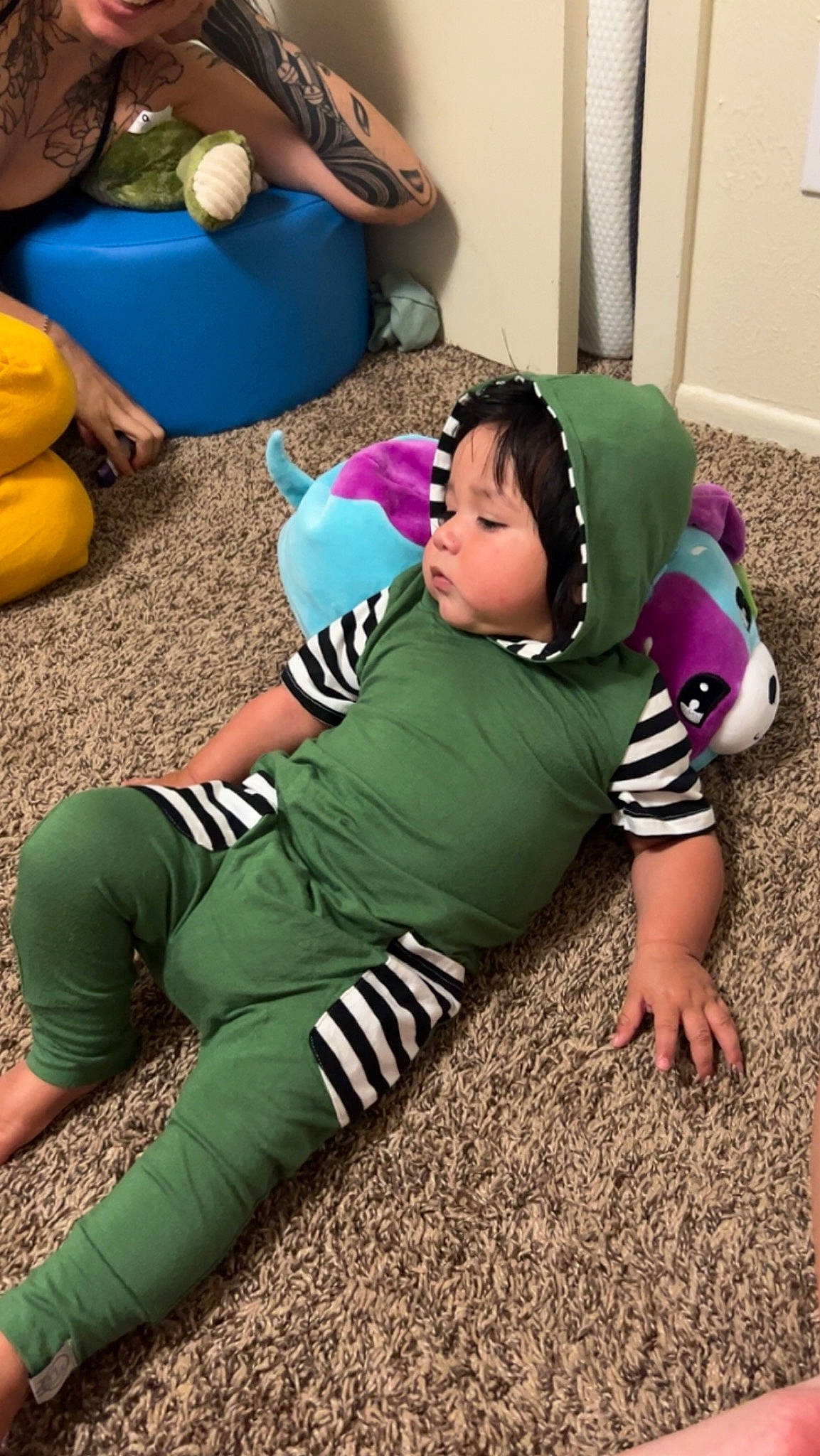 Darius is registered to the contest to win money with this photo: arm, ball, child, comfort, cool, fun, grass, happy, headgear, human_leg, knee, leg, leisure, person, sitting, sleeve, sneakers, sportswear, t_shirt, thigh