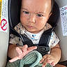 Kendrick joined the competition — help win amazing prizes! baby, baby_boy, baby_girl, blanket, car_seat, child, close_up, clothing, cute, face, hand, indoors, infant, infant_clothing, person, safety_harness, seatbelt, serious_expression, warning_label, young_child
